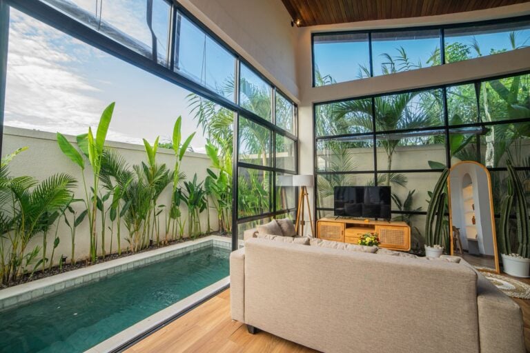 Modern living room overlooking pool and garden.