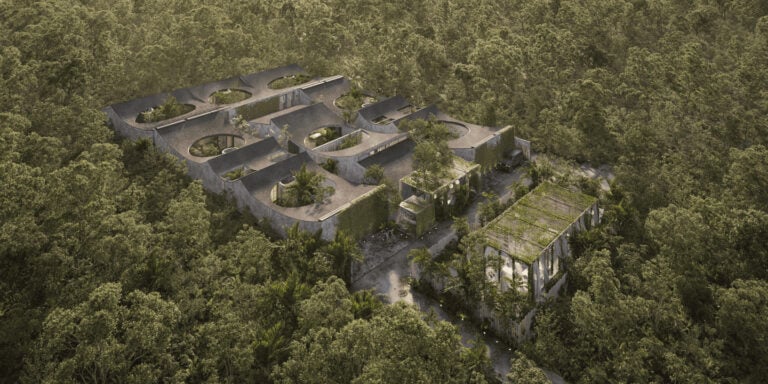 Aerial view of modern buildings surrounded by trees.