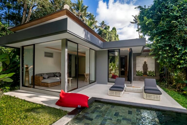 Modern villa with pool and outdoor lounge area.