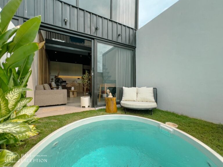 Modern villa with small pool and garden seating.