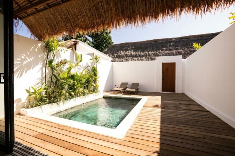 Private tropical patio with pool and loungers.