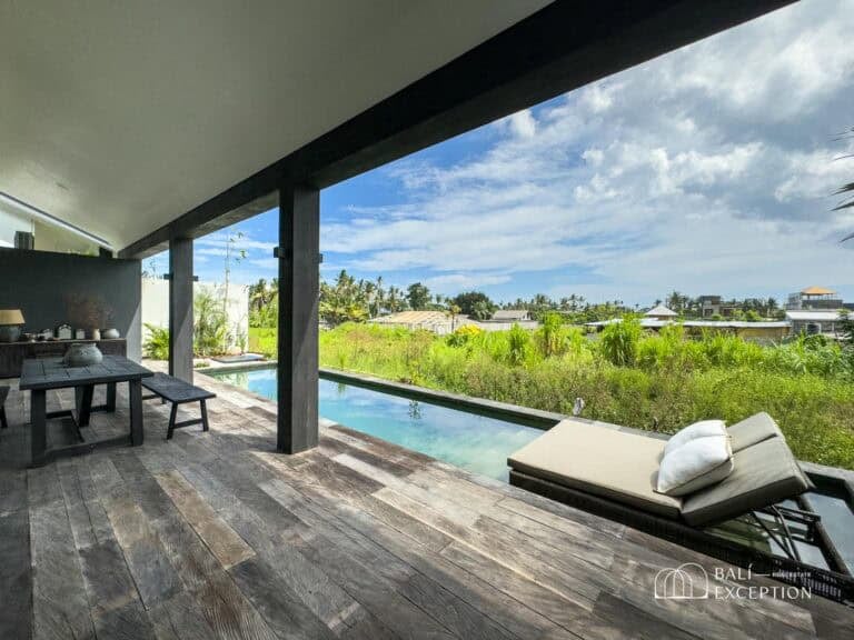 Outdoor patio with pool and countryside view.