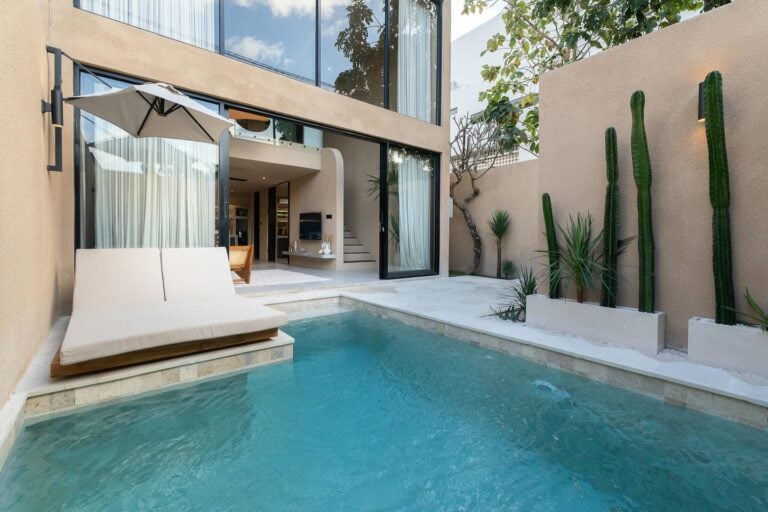 Modern house with pool and patio lounge.