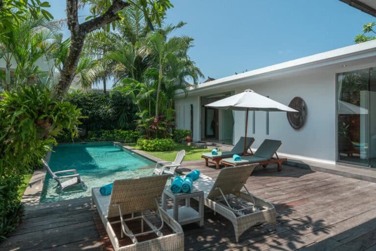 Luxury villa with pool and lounge chairs