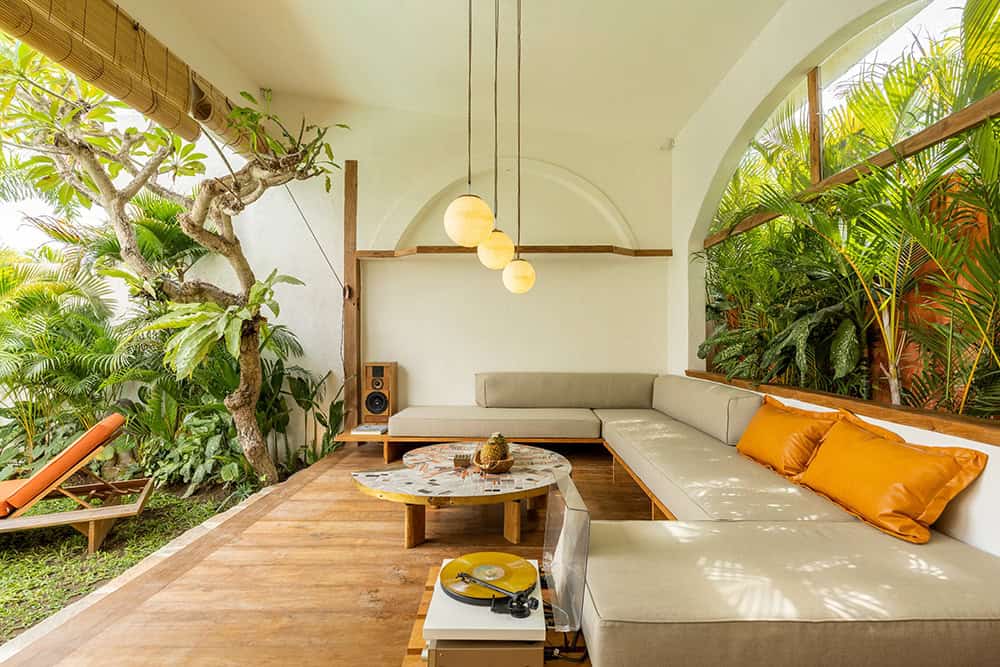 Cozy outdoor living space with tropical plants.