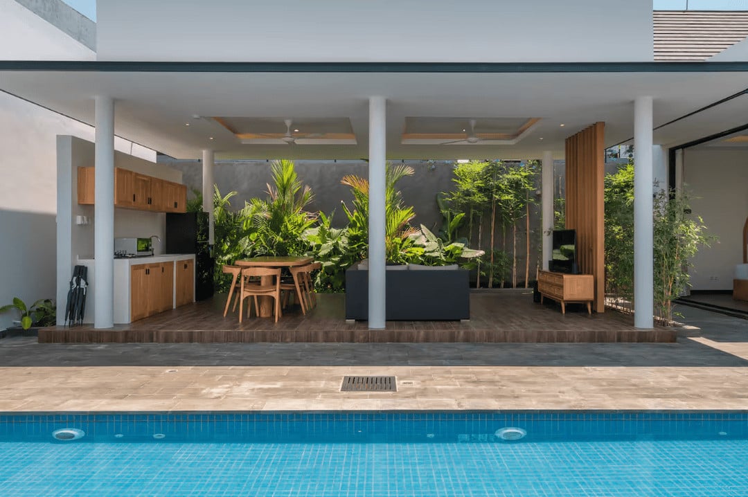 Modern outdoor patio with pool and seating area
