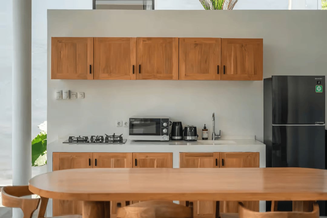 Modern kitchen with wooden cabinets and appliances.